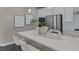 Kitchen area with an island, white cabinets, stainless steel appliances, and contemporary decorative accents at 2246 Bird Of Prey St, Las Vegas, NV 89138