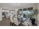 Modern dining room next to kitchen with sleek furniture, stylish chandelier, view of backyard and city lights at 2246 Bird Of Prey St, Las Vegas, NV 89138