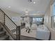 Open-concept living room featuring stylish decor, seamless flow to dining area, and natural light at 2246 Bird Of Prey St, Las Vegas, NV 89138