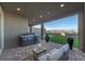 Outdoor living space features a built-in grill, brick patio, and a lush backyard at 2246 Bird Of Prey St, Las Vegas, NV 89138
