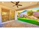 Cozy patio area with brick flooring and view to the artificial turf backyard at 2386 Millergrove Ave, North Las Vegas, NV 89086