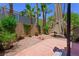 Private backyard with patio, mature trees, and desert landscaping at 245 Homesteader Ct, Henderson, NV 89052