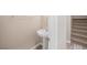 Powder room featuring a pedestal sink, neutral wall color, and an updated faucet at 245 Homesteader Ct, Henderson, NV 89052