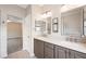 Bright bathroom featuring double sinks, gray cabinetry and modern lighting fixtures at 245 Homesteader Ct, Henderson, NV 89052