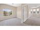 Well-lit bedroom with neutral paint, carpet, and a view of the exterior neighborhood at 245 Homesteader Ct, Henderson, NV 89052