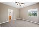 Cozy bedroom with ceiling fan and view of backyard at 245 Homesteader Ct, Henderson, NV 89052
