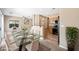 Dining room area featuring a glass table, kitchen access and adjacent living room at 245 Homesteader Ct, Henderson, NV 89052