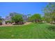 Well-manicured lawn and landscaping surround this charming community at 245 Homesteader Ct, Henderson, NV 89052