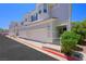Inviting townhome featuring a two-car garage and lovely architectural details on a bright, sunny day at 245 Homesteader Ct, Henderson, NV 89052