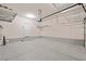 Clean and organized garage featuring epoxy floors and overhead storage solutions at 245 Homesteader Ct, Henderson, NV 89052