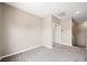 Carpeted hallway with neutral paint leading to the bedrooms and stairway at 245 Homesteader Ct, Henderson, NV 89052