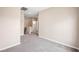 Carpeted hallway with neutral paint leading to the bedrooms and laundry area at 245 Homesteader Ct, Henderson, NV 89052