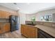 Bright and efficient kitchen featuring a stainless steel refrigerator, modern appliances, and a view to the yard at 245 Homesteader Ct, Henderson, NV 89052