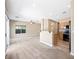 Open-concept living room featuring neutral paint, carpet, and a breakfast bar to the adjacent kitchen at 245 Homesteader Ct, Henderson, NV 89052