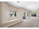 Bright living room featuring neutral paint, carpet, built-in bench, and a sliding glass door at 245 Homesteader Ct, Henderson, NV 89052
