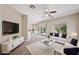 Open concept living room featuring a ceiling fan, plush seating, and a view into the dining area at 245 Homesteader Ct, Henderson, NV 89052