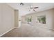 Spacious living room featuring carpeted floors, neutral walls, and a view of the backyard at 245 Homesteader Ct, Henderson, NV 89052