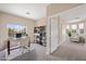 Well-lit office with a glass desk, comfortable chair, and a wall-mounted bookcase at 245 Homesteader Ct, Henderson, NV 89052
