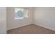 An empty bedroom filled with neutral carpet, baseboards, and a window to bring in natural light at 2455 Silver Blossom Ln, Henderson, NV 89052