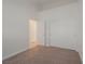 A well-lit bedroom featuring neutral carpet, baseboards, and closet for ample storage at 2455 Silver Blossom Ln, Henderson, NV 89052