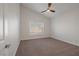 Bright bedroom featuring neutral carpet, a ceiling fan and a window at 2455 Silver Blossom Ln, Henderson, NV 89052