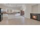 Contemporary kitchen with a breakfast island, fireplace and access to the backyard at 2455 Silver Blossom Ln, Henderson, NV 89052