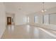 Open-concept living room with tile flooring and lots of natural light at 2455 Silver Blossom Ln, Henderson, NV 89052