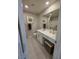 Bright bathroom with a single vanity and a decorative mirror at 2497 Rofrano Pl, Henderson, NV 89044
