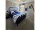 Well-lit bedroom with carpet, aircraft art and a metal frame bed at 2497 Rofrano Pl, Henderson, NV 89044