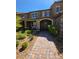 Charming townhouse with a stone-accented facade, covered porch, and a well-manicured front yard at 2497 Rofrano Pl, Henderson, NV 89044