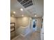 Upstairs hallway featuring neutral carpet and paint with recessed lighting, leading to other rooms at 2497 Rofrano Pl, Henderson, NV 89044