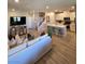Open concept floor plan boasting a spacious living room and a modern kitchen with an island at 2497 Rofrano Pl, Henderson, NV 89044