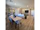 Bright, open-concept living and dining area with hardwood floors and modern decor at 2497 Rofrano Pl, Henderson, NV 89044