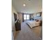 Spacious main bedroom with a large window, plush carpet, and a decorative headboard at 2497 Rofrano Pl, Henderson, NV 89044