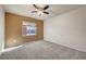Bright bedroom features neutral carpet, ceiling fan, and a view of the community pool at 2520 Eclipsing Stars Dr, Henderson, NV 89044