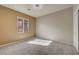 Bright bedroom with neutral carpet, a ceiling fan, and a view to the outside at 2520 Eclipsing Stars Dr, Henderson, NV 89044