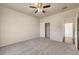 Bright bedroom with neutral carpet, a ceiling fan, and a convenient closet for storage at 2520 Eclipsing Stars Dr, Henderson, NV 89044