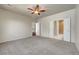 Spacious bedroom with ceiling fan and bathroom and closet entrances at 2520 Eclipsing Stars Dr, Henderson, NV 89044