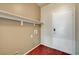 Practical laundry room with overhead shelving and a contrasting wood-look floor at 2520 Eclipsing Stars Dr, Henderson, NV 89044