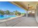 Covered patio area with a ceiling fan overlooking the pool and outdoor space at 2520 Eclipsing Stars Dr, Henderson, NV 89044