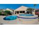 Backyard pool and raised spa with decorative tiling and concrete patio at 2520 Eclipsing Stars Dr, Henderson, NV 89044