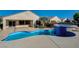 Backyard pool and raised spa with blue tile accents and covered patio at 2520 Eclipsing Stars Dr, Henderson, NV 89044