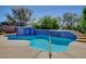 Sparkling pool featuring a tiled waterfall edge, concrete decking, and mature landscaping at 2520 Eclipsing Stars Dr, Henderson, NV 89044