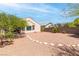 Large gravel backyard with stone accents, mature trees, and a peaceful setting at 2799 Alnwick Ct, Henderson, NV 89044