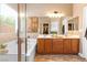 Bathroom featuring double sinks, a walk-in closet, a soaking tub, and a separate shower at 2799 Alnwick Ct, Henderson, NV 89044