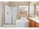 Beautiful bathroom featuring a shower, soaking tub, and a neutral color palette at 2799 Alnwick Ct, Henderson, NV 89044