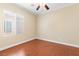Bedroom featuring wood-look flooring, a ceiling fan, and a window bringing in natural light at 2799 Alnwick Ct, Henderson, NV 89044