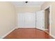 Bedroom with wood-look flooring, white trim and doors, and a spacious closet at 2799 Alnwick Ct, Henderson, NV 89044