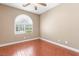 Bedroom with wood-look flooring and an arched window allowing for ample natural light at 2799 Alnwick Ct, Henderson, NV 89044