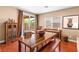 Charming dining room featuring hardwood floors, a wooden table with a bench, and access to outdoor area at 2799 Alnwick Ct, Henderson, NV 89044